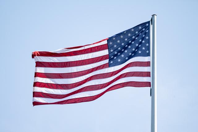 FILED - 22 June 2025, Berlin: The flag of the USA flies, here at the US embassy in Berlin. European ratings agency Scope has downgraded the creditworthiness of the United States, citing "sustained deterioration in public finances and a weakening of governance standards." Photo: Fabian Sommer/dpa