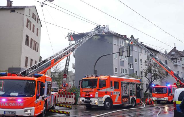 25 October 2025, Stuttgart: Firefighters extinguish a blaze after a roof truss fire in an apartment building triggered a major operation involving three turntable ladders and numerous crews. One firefighter was injured during the operation, according to a fire department spokesperson. Photo: Andreas Rosar/Fotoagentur-Stuttgart/dpa