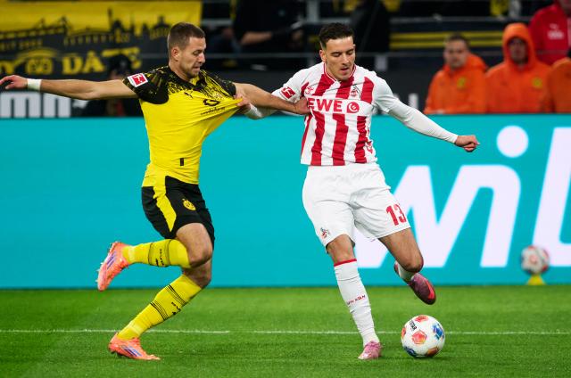 25 October 2025, North Rhine-Westphalia, Dortmund: Borussia Dortmund's Waldemar Anton and Cologne's Said El Mala in action during the German Bundesliga soccer match between Borussia Dortmund and 1. FC Cologne at the Signal Iduna Park. Photo: Bernd Thissen/dpa - IMPORTANT NOTICE: DFL and DFB regulations prohibit any use of photographs as image sequences and/or quasi-video.