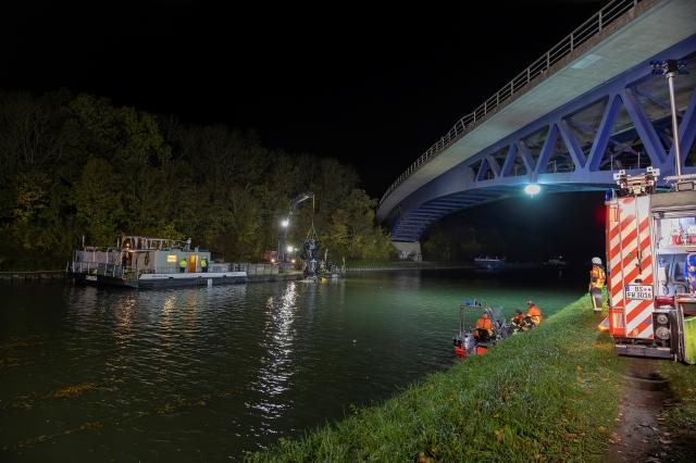 25 October 2025, Lower Saxony, Brunswick: A car is retrieved from the water by a crane after it fell off a bridge into the Mittelland Canal during a serious accident involving several vehicles on the federal highway near 4 Braunschweig. Photo: Stefan Sobotta/dpa