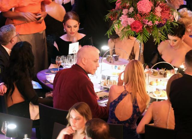 25 October 2025, Saxony, Leipzig: Till Lindemann (C), lead singer of the band Rammstein, sits at a table at the Leipzig Opera Ball. Several hundred people gathered outside the Leipzig Opera House to protest the invitation to the controversial Rammstein singer Till Lindemann to be a special guest at Saturday's Leipzig Opera Ball. Photo: Sebastian Willnow/dpa