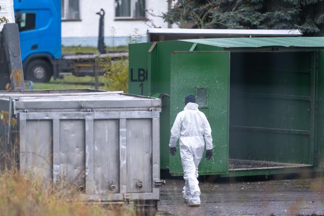 27 October 2025, Brandenburg, Neuhardenberg: A man in a white protective suit walks across a facility infested with avian influenza. Avian influenza, also known as bird flu, has now spread across almost the whole of Germany. Photo: Christophe Gateau/dpa