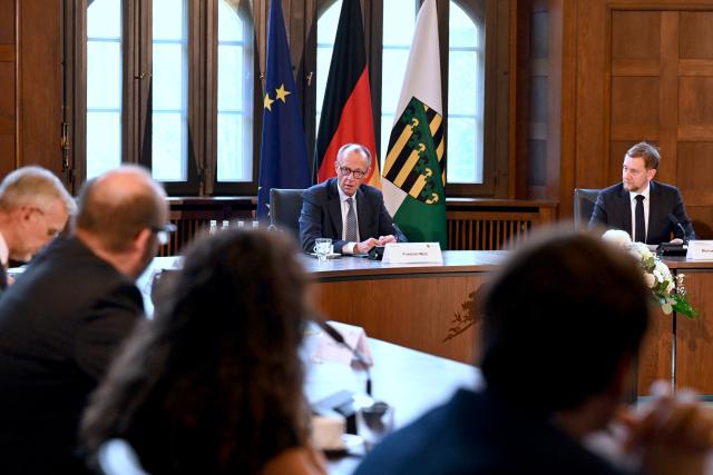 28 October 2025, Saxony, Dresden: German Chancellor Friedrich Merz sits next to Michael Kretschmer (R), Minister President of Saxony, at the start of a cabinet meeting during his inaugural visit to Saxony State Chancellery. Photo: Hendrik Schmidt/dpa