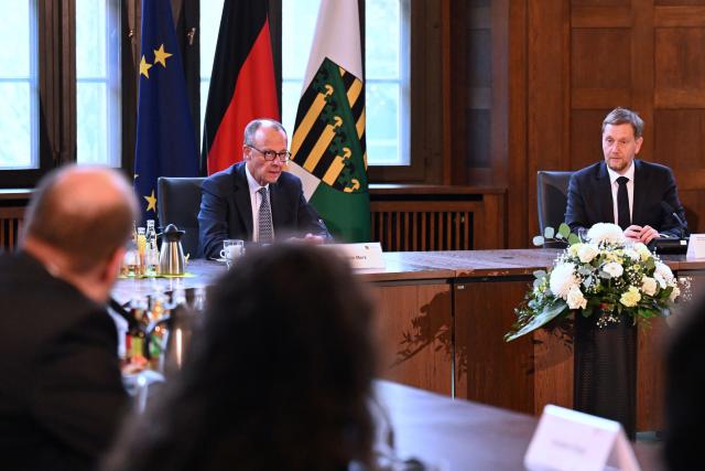 28 October 2025, Saxony, Dresden: German Chancellor Friedrich Merz sits next to Michael Kretschmer (R), Minister President of Saxony, at the start of a cabinet meeting during his inaugural visit to Saxony State Chancellery. Photo: Hendrik Schmidt/dpa