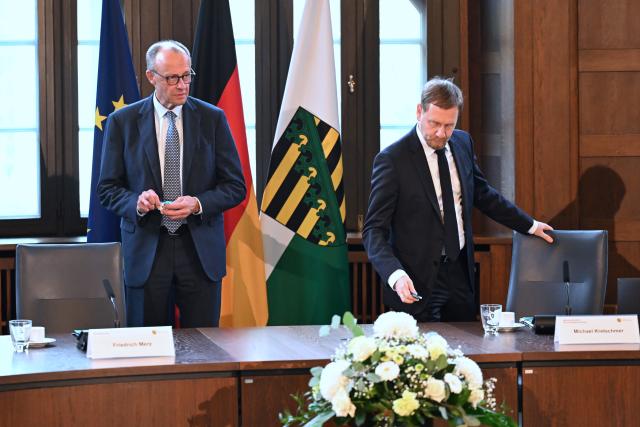 28 October 2025, Saxony, Dresden: German Chancellor Friedrich Merz takes a seat next to Michael Kretschmer (R), Minister President of Saxony, at the start of a cabinet meeting during his inaugural visit to Saxony State Chancellery. Photo: Hendrik Schmidt/dpa