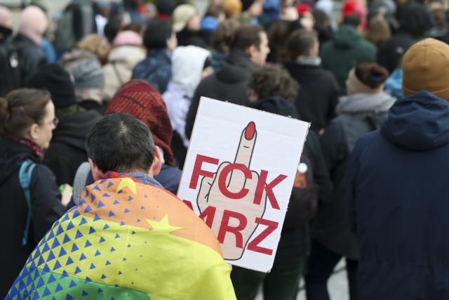28 October 2025, Saxony, Dresden: A demonstrator holds a placard with the inscription "Fck Mrz" at a demonstration during German Chancellor Friedrich Merz's inaugural visit to the Saxon State Chancellery. Photo: Jan Woitas/dpa