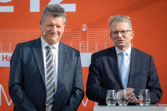 28 October 2025, Lower Saxony, Wilhelmshaven: Holger Bomm (L) and Holger Banik speak at the naming ceremony for the container ship "Wilhelmshaven Express", one of Hapag-Lloyd's largest vessels and the final ship in its Hamburg class. Photo: Sina Schuldt/dpa