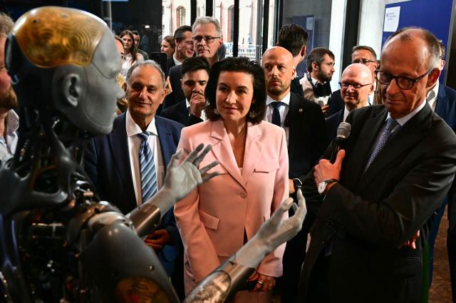 29 October 2025, Berlin: Dorothee Baer (2nd R), German Minister for Research, Technology and Aerospace, and Chancellor Friedrich Merz (R) inspect the humanoid robot "Ameca", designed for the care sector, at the presentation of the so-called "Hightech Agenda Germany - Debate, Conference, Networking" on the EUREF
-Campus. Photo: Tobias Schwarz/POOL AFP/dpa