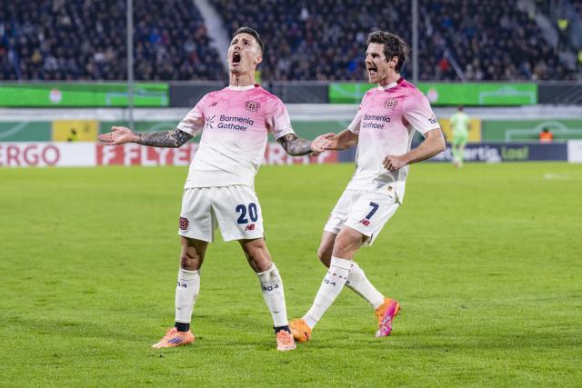 29 October 2025, North Rhine-Westphalia, Paderborn: Bayer Leverkusen's Alex Grimaldo (L) celebrates after scoring his side's first goal of the game during the German DFB Cup 2nd round soccer match between SC Paderborn 07 and Bayer Leverkusen at Home Deluxe Arena. Photo: David Inderlied/dpa - WICHTIGER HINWEIS: Gemäß den Vorgaben der DFL Deutsche Fußball Liga bzw. des DFB Deutscher Fußball-Bund ist es untersagt, in dem Stadion und/oder vom Spiel angefertigte Fotoaufnahmen in Form von Sequenzbildern und/oder videoähnlichen Fotostrecken zu verwerten bzw. verwerten zu lassen.