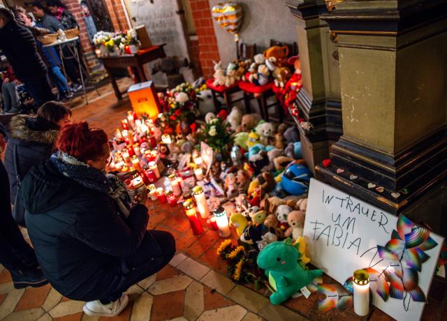 30 October 2025, Mecklenburg-Western Pomerania, Guestrow: Visitors to the funeral service for eight-year-old Fabian place candles among cuddly toys at the entrance to St. Mary's Church. The boy's body was found in a forest near Guestrow on 14 October 2025, four days after he went missing. Photo: Jens Büttner/dpa