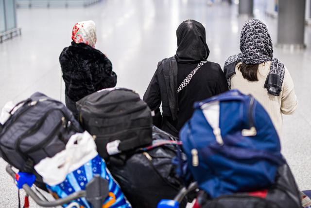 30 October 2025, Lower Saxony, Langenhagen: Afghan nationals who have just arrived at Hanover-Langenhagen Airport walk through a waiting hall after being granted admission to Germany. Photo: Moritz Frankenberg/dpa