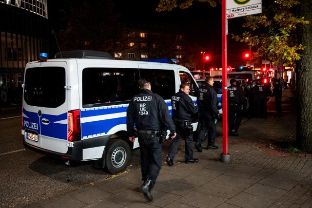 31 October 2025, Hamburg: Police officers walk through the Harburg district during the Halloween celebrations. Photo: Daniel Bockwoldt/dpa