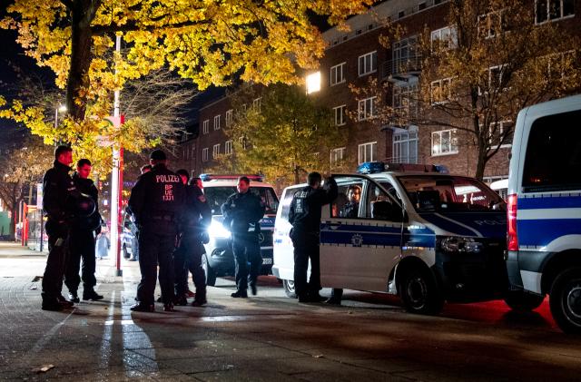 31 October 2025, Hamburg: Police officers stand in the Harburg district during the Halloween celebrations. Photo: Daniel Bockwoldt/dpa
