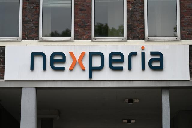 FILED - 25 August 2025, Hamburg: The logo of the semiconductor manufacturer "Nexperia" hangs above the entrance to the company building. Photo: David Hammersen/dpa
