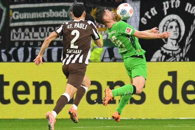 01 November 2025, Hamburg: Hamburg's Manolis Saliakas (L) and Moenchengladbach's Lukas Ullrich battle for the ball during the German Bundesliga soccer match between FC St. Pauli and Borussia Moenchengladbach at the Millerntorstadion. Photo: Daniel Bockwoldt/dpa - WICHTIGER HINWEIS: Gemäß den Vorgaben der DFL Deutsche Fußball Liga bzw. des DFB Deutscher Fußball-Bund ist es untersagt, in dem Stadion und/oder vom Spiel angefertigte Fotoaufnahmen in Form von Sequenzbildern und/oder videoähnlichen Fotostrecken zu verwerten bzw. verwerten zu lassen.