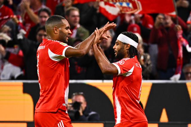 01 November 2025, Bavaria, Munich: Bayern Munich's Serge Gnabry (R) celebrates scoring his side's first goal with teammate Jonathan Tah during the German Bundesliga soccer match between FC Bayern Munich and Bayer Leverkusen at Allianz Arena. Photo: Tom Weller/dpa - IMPORTANT NOTICE: DFL and DFB regulations prohibit any use of photographs as image sequences and/or quasi-video.