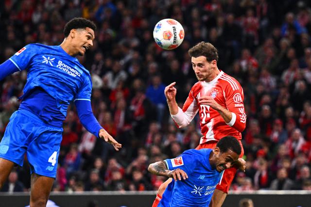 01 November 2025, Bavaria, Munich: Bayern Munich's Leon Goretzka (R) battles for the ball with Bayer Leverkusen's Jarell Quansah (L) and Arthur during the German Bundesliga soccer match between FC Bayern Munich and Bayer Leverkusen at Allianz Arena. Photo: Tom Weller/dpa - IMPORTANT NOTICE: DFL and DFB regulations prohibit any use of photographs as image sequences and/or quasi-video.
