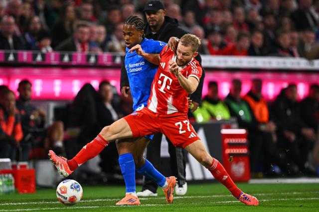 01 November 2025, Bavaria, Munich: Bayern Munich's Konrad Laimer (R) and Bayer Leverkusen's Jeanuel Belocian battle for the ball during the German Bundesliga soccer match between FC Bayern Munich and Bayer Leverkusen at Allianz Arena. Photo: Tom Weller/dpa - IMPORTANT NOTICE: DFL and DFB regulations prohibit any use of photographs as image sequences and/or quasi-video.