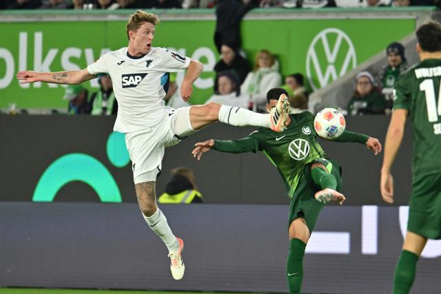 02 November 2025, Lower Saxony, Wolfsburg: Hoffenheim's Wouter Burger (L) and Wolfsburg's Adam Daghim battle for the ball during the German Bundesliga soccer match between VfL Wolfsburg and TSG Hoffenheim at the Volkswagen Arena. Photo: Swen Pförtner/dpa - IMPORTANT NOTICE: DFL and DFB regulations prohibit any use of photographs as image sequences and/or quasi-video.