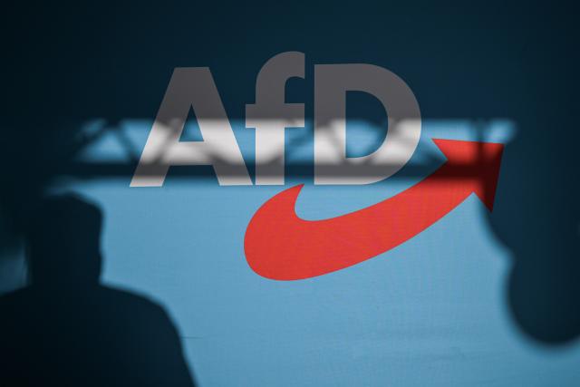 FILED - 08 August 2024, Thuringia, Bad Salzungen: A speaker casts a shadow on the back wall of the stage with AfD lettering at an event. Photo: Hannes P Albert/dpa