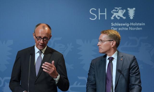 03 November 2025, Schleswig-Holstein, Husum: Germany's Chancellor Friedrich Merz (L) and Daniel Guenther, Minister-President of Schleswig-Holstein, speak during a joint press conference at the Schifffahrtsmuseum Nordfriesland. The Federal Chancellor is on his inaugural visit to Schleswig-Holstein. Photo: Marcus Brandt/dpa