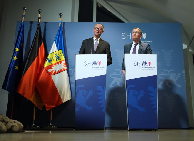 03 November 2025, Schleswig-Holstein, Husum: Germany's Chancellor Friedrich Merz (L) and Daniel Guenther, Minister-President of Schleswig-Holstein, speak during a joint press conference at the Schifffahrtsmuseum Nordfriesland. The Federal Chancellor is on his inaugural visit to Schleswig-Holstein. Photo: Marcus Brandt/dpa