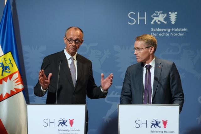 03 November 2025, Schleswig-Holstein, Husum: Germany's Chancellor Friedrich Merz (L) and Daniel Guenther, Minister-President of Schleswig-Holstein, speak during a joint press conference at the Schifffahrtsmuseum Nordfriesland. The Federal Chancellor is on his inaugural visit to Schleswig-Holstein. Photo: Marcus Brandt/dpa