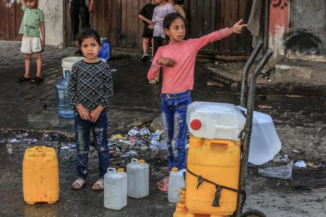 FILED - 17 April 2024, Gaza Strip, Rafah: Palestinian children queue up with water containers to fill them with drinking water. Around 520 million children worldwide lived in conflict zones in 2024, 47 million more than the previous year and the highest number recorded since 2005, according to a report by Save the Children published on Tuesday. Photo: Abed Rahim Khatib/dpa