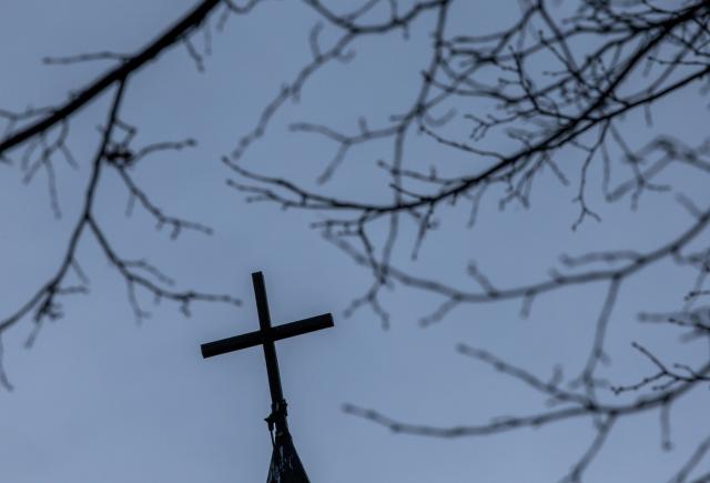 PRODUCTION - 28 January 2025, Mecklenburg-Western Pomerania, Pogress: A church cross on the roof of the deconsecrated former Catholic Church of the Nativity of the Virgin Mary. A 110-year-old believed to have been the oldest man in Germany has died. Photo: Jens Büttner/dpa