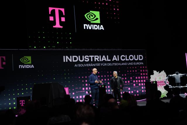 04 November 2025, Berlin: Tim Hoettges (L), CEO of Deutsche Telekom AG, and Jensen Huang (R), CEO of NVIDIA, attend the presentation of a new AI factory jointly developed by Deutsche Telekom and NVIDIA. The collaboration aims to lay the foundation for a new era of artificial intelligence (AI) in Germany and across Europe. Photo: Carsten Koall/dpa