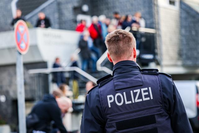 04 November 2025, North Rhine-Westphalia, Herdecke: A police officer stands near the council chamber in Herdecke, where local politician I. Stalzer is sworn in as the new mayor less than a month after surviving a life-threatening knife attack on November 4, 2025. It marks the SPD politician's first public appearance since the incident. Photo: Christoph Reichwein/dpa