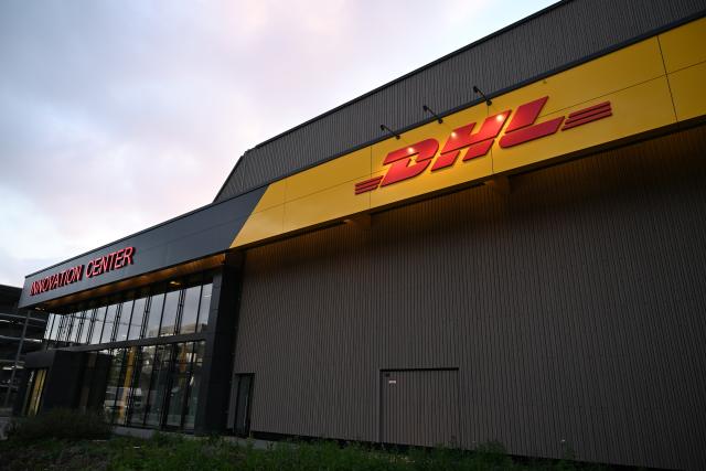 FILED - 30 September 2025, North Rhine-Westphalia, Troisdorf: The DHL logo can be seen at the new DHL Innovation Center. Photo: Wolf von Dewitz/dpa