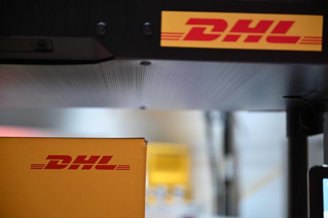 FILED - 30 September 2025, North Rhine-Westphalia, Troisdorf: The DHL logo can be seen at the new DHL Innovation Center in Troisdorf. Photo: Wolf von Dewitz/dpa
