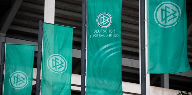 FILED - 28 May 2022, North Rhine-Westphalia, Cologne: Flags with the logo of the German Football Federation (DFB) fly outside the RheinEnergie stadium. Photo: Fabian Strauch/dpa