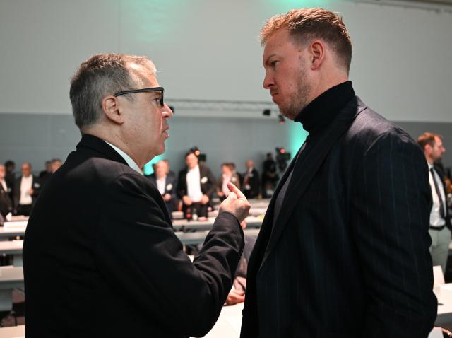 07 November 2025, Hesse, Frankfurt/Main: Julian Nagelsmann (R), national coach, and Andreas Rettig, Managing Director of Sport at the German Football Association (DFB), talk in the plenary hall during the 45th German Football Association National Conference (Bundestag) at the DFB campus. Photo: Arne Dedert/dpa