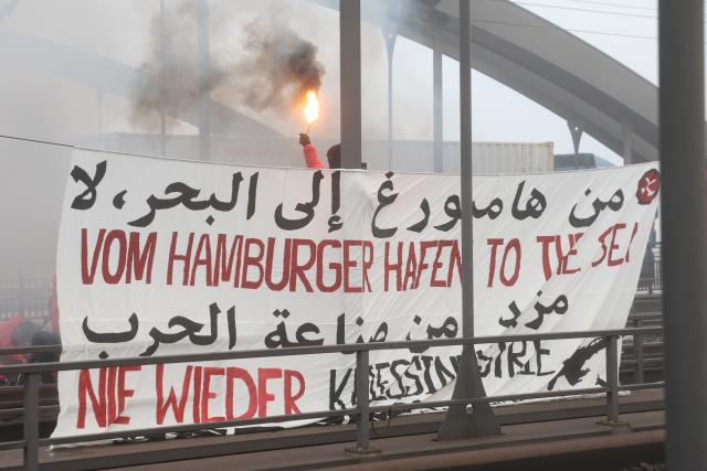 07 November 2025, Hamburg: Activists from the "Ende Gelaende" group and Palestine solidarity groups hold a large banner while occupying rail tracks on the Waltershofer Bridge in the port of Hamburg, calling for a stop to arms exports to Israel. Photo: Bodo Marks/dpa