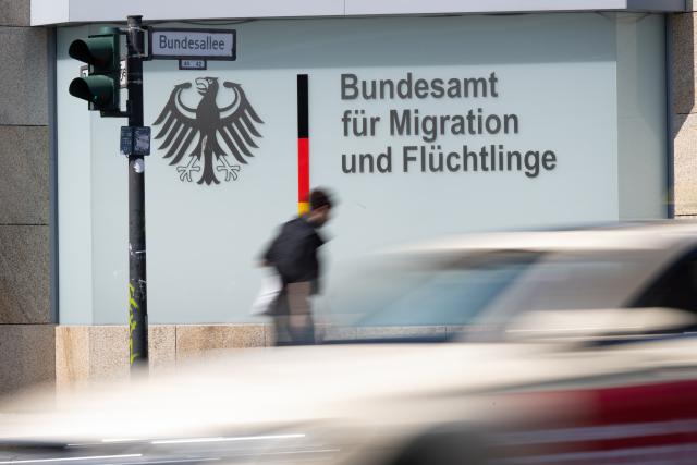 FILED - 24 August 2023, Berlin: A man passes in front of the German Office for Migration and Refugees (BAMF) in Berlin. Photo: Sebastian Gollnow/dpa