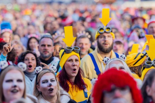 11 November 2025, North Rhine-Westphalia, Cologne: People celebrate the start of the carnival season on the Heumarkt. The carnival season begins on 11.11. at 11:11 am in the carnival strongholds. Photo: Rolf Vennenbernd/dpa