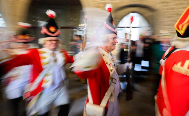 11 November 2025, Lower Saxony, Brunswick: Carnival members of the Karneval-Vereinigung der Rheinlaender e.V. Braunschweig walk into the old town hall at the carnival kick-off. Photo: Julian Stratenschulte/dpa