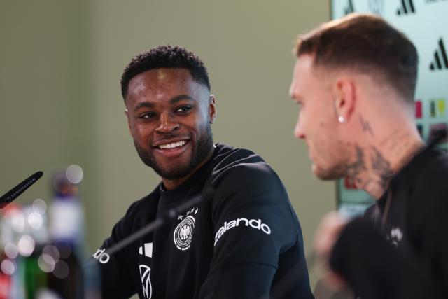 11 November 2025, Lower Saxony, Wolfsburg: Germany's David Raum and Ridle Baku attend the team's press conference ahead of the FIFA World Cup European qualifying soccer matches against Luxembug and Slovakia. Photo: Christian Charisius/dpa
