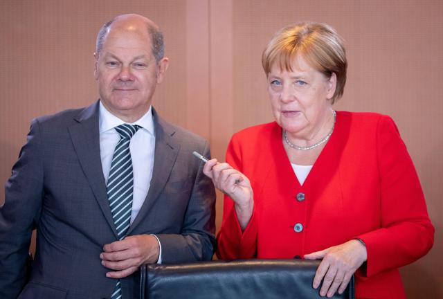 FILED - 19 June 2019, Berlin: Then German Chancellor Angela Merkel and Olaf Scholz, then Minister of Finance, take part in a cabinet meeting in Berlin. Photo: Kay Nietfeld/dpa