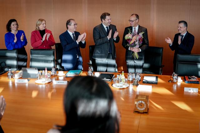 12 November 2025, Berlin: German Chancellor Friedrich Merz  accepts the applause and flowers on the occasion of his 70th birthday on November 11, 2025 at the beginning of the meeting of the Federal Cabinet in the Federal Chancellery. Photo: Kay Nietfeld/dpa