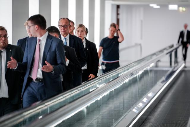 13 November 2025, Berlin: German Chancellor Friedrich Merz (C) walks through the connecting tunnel from the Reichstag building to the Jakob-Kaiser-Haus, as the governing parties meet in the Jakob-Kaiser-Haus for the coalition committee. Photo: Kay Nietfeld/dpa