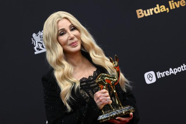 13 November 2025, Bavaria, Gruenwald: US singer and actress Cher shows off her BAMBI, the "Legend" category, during the 77th Bambi Award Ceremony at the Bavaria Film Studios. Photo: Felix Hörhager/dpa