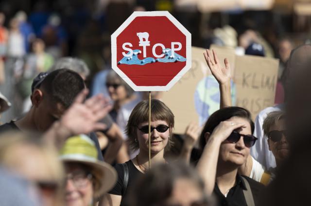 FILED - 20 September 2025, Hesse, Frankfurt/Main: "Stop" is written on the poster of a woman taking part in a "Fridays for Future" protest march in the city center. Photo: Boris Roessler/dpa