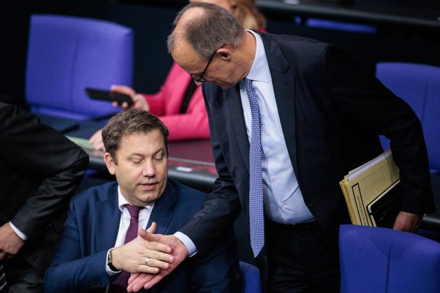 14 November 2025, Berlin: German Chancellor Friedrich Merz (R) welcomes Lars Klingbeil, German Minister of Finance, at the start of the plenary session in the German Bundestag. Photo: Carsten Koall/dpa