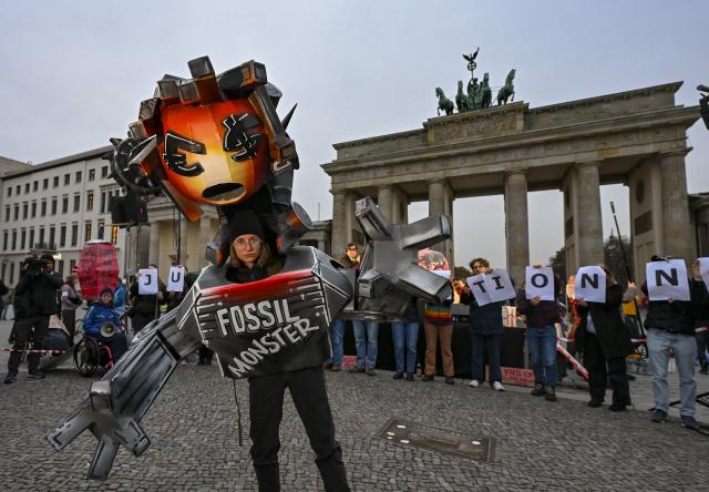 14 November 2025, Berlin: Demonstrators from the Fridays for Future climate movement stand at the Brandenburg Gate on the occasion of the COP30 world climate conference. Photo: Jens Kalaene/dpa
