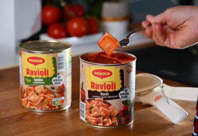 FILED - 08 May 2023, Baden-Württemberg, Stuttgart: A person grabs a fork of canned ravioli in a kitchen. The European Commission is considering proposing a levy next year on highly processed foods with high fat, sugar and salt content, according to a draft document seen by dpa on Sunday. Photo: Bernd Weißbrod/dpa