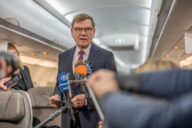 16 November 2025, Brandenburg, Schoenefeld: Johann Wadephul, Germany's Foreign Minister, speaks to reporters on the plane before taking off for the Western Balkans countries. Photo: Michael Kappeler/dpa