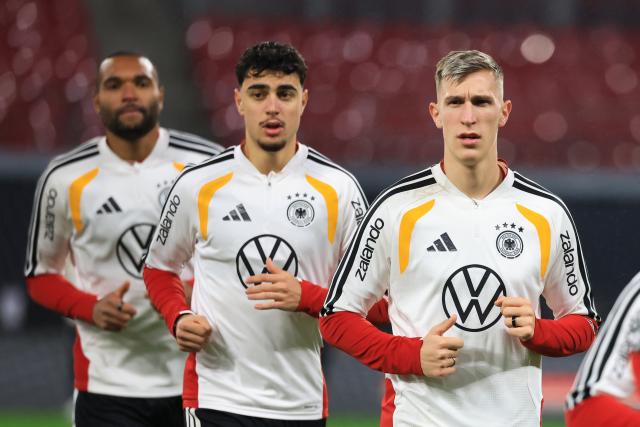16 November 2025, Saxony, Leipzig: (R-L) Germany's Nico Schlotterbeck, Aleksandar Pavlovic and Jonathan Tah in action during a training session ahead of the FIFA World Cup European qualifying soccer match against Slovakia. Photo: Jan Woitas/dpa